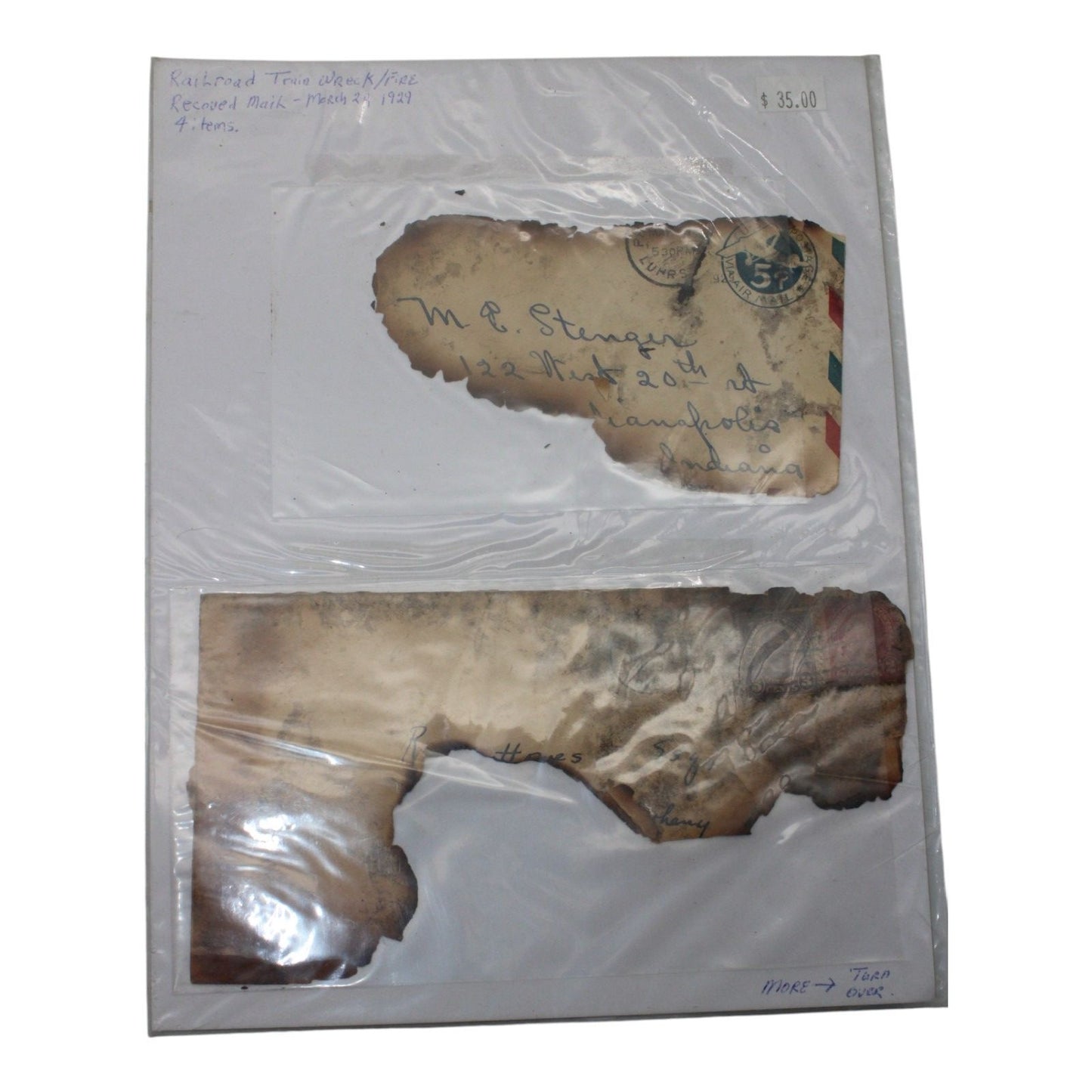 Burned envelope fragments from 1929 mail salvaged after a railroad train wreck and fire, partially legible with original postmark visible.