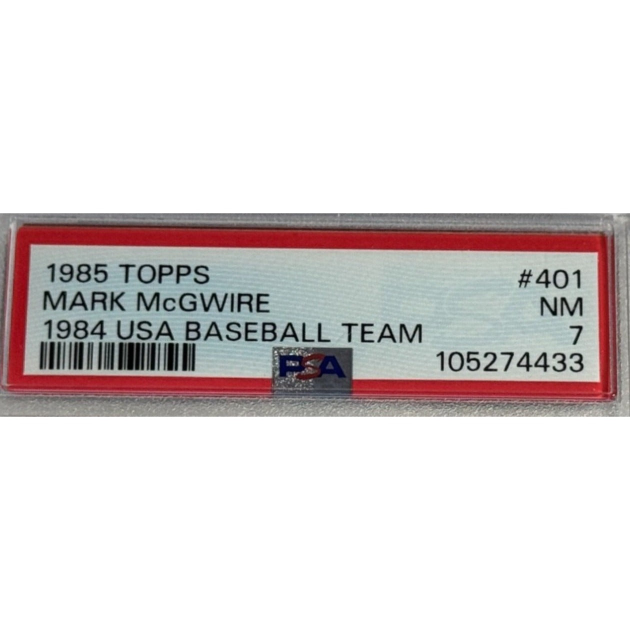 A PSA 7 near‑mint 1985 Topps #401 Mark McGwire rookie card featuring him in the 1984 USA Baseball Team uniform, an iconic Olympic‑era collectible.
