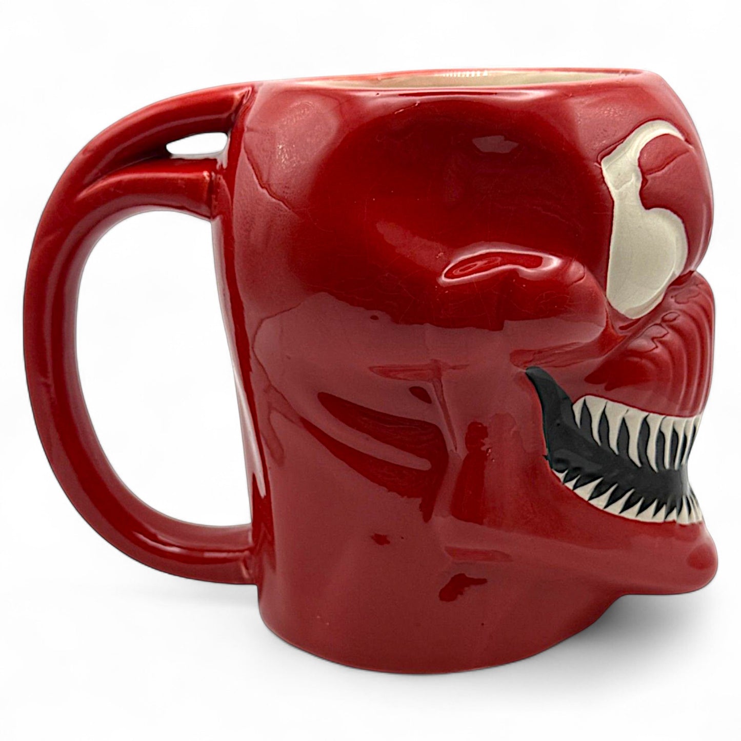 Side view of Carnage mug showing handle and sharp teeth detailing on red Marvel coffee mug