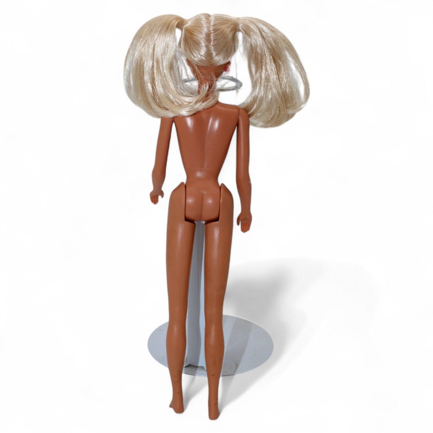 Vintage Mattel Ponytail Barbie #4 doll from 1960 with rooted blonde hair, hard plastic body, and iconic facial paint, in used condition.