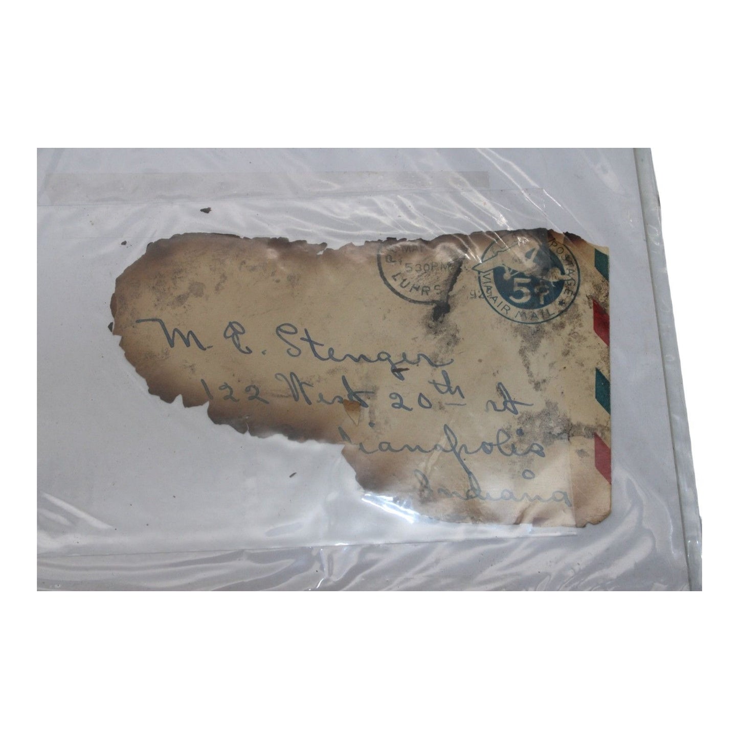 Vintage letter with stamps and handwriting inside a clear protective sleeve.