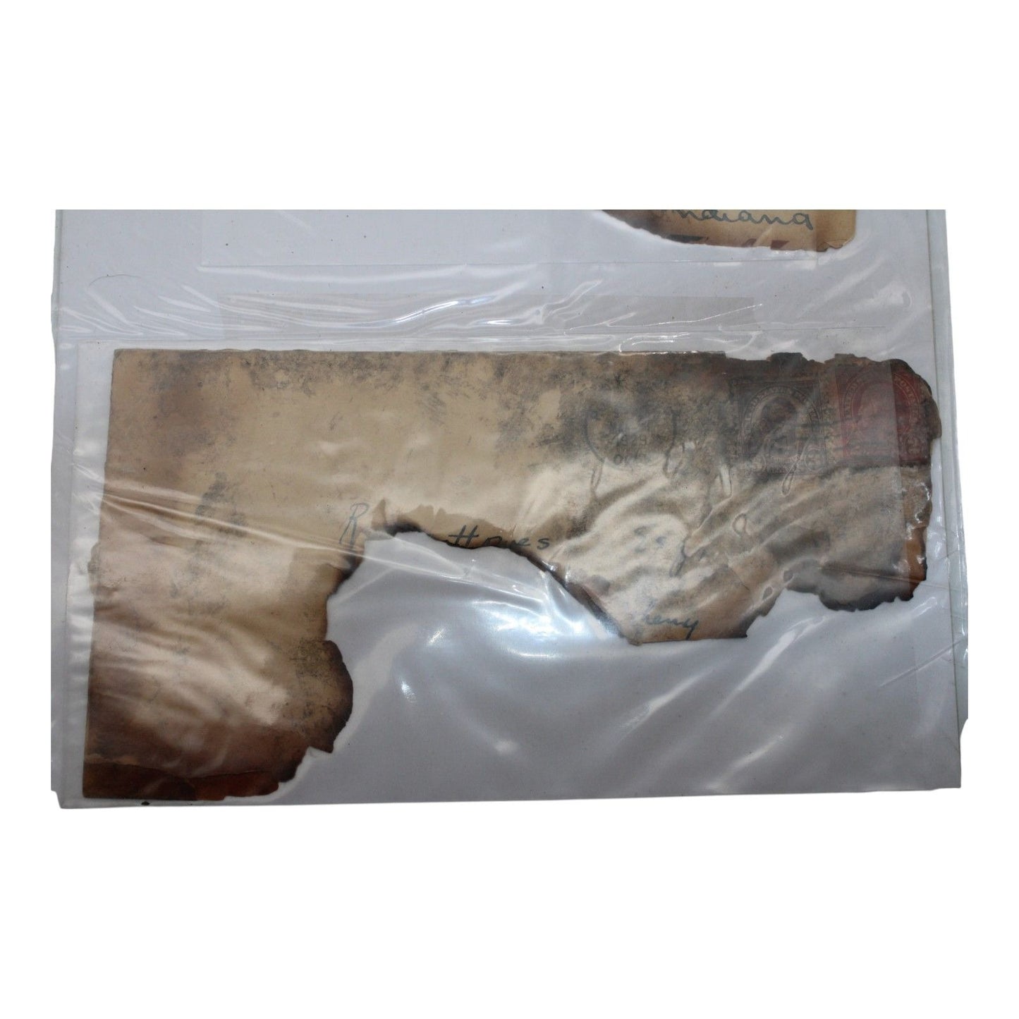 Burned envelope fragments from 1929 mail salvaged after a railroad train wreck and fire, partially legible with original postmark visible.