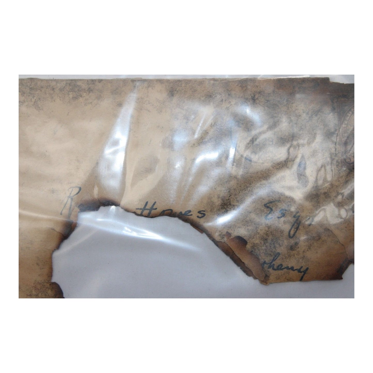 Burned envelope fragments from 1929 mail salvaged after a railroad train wreck and fire, partially legible with original postmark visible.