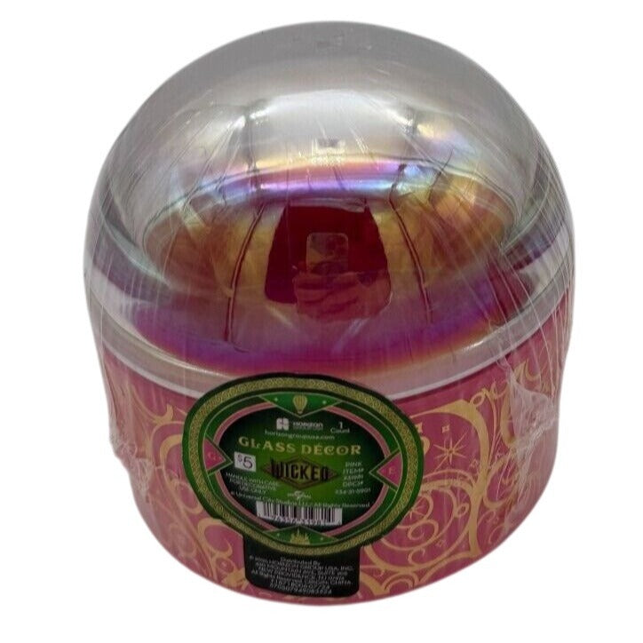 Iridescent glass bubble with pink and gold hues in packaging