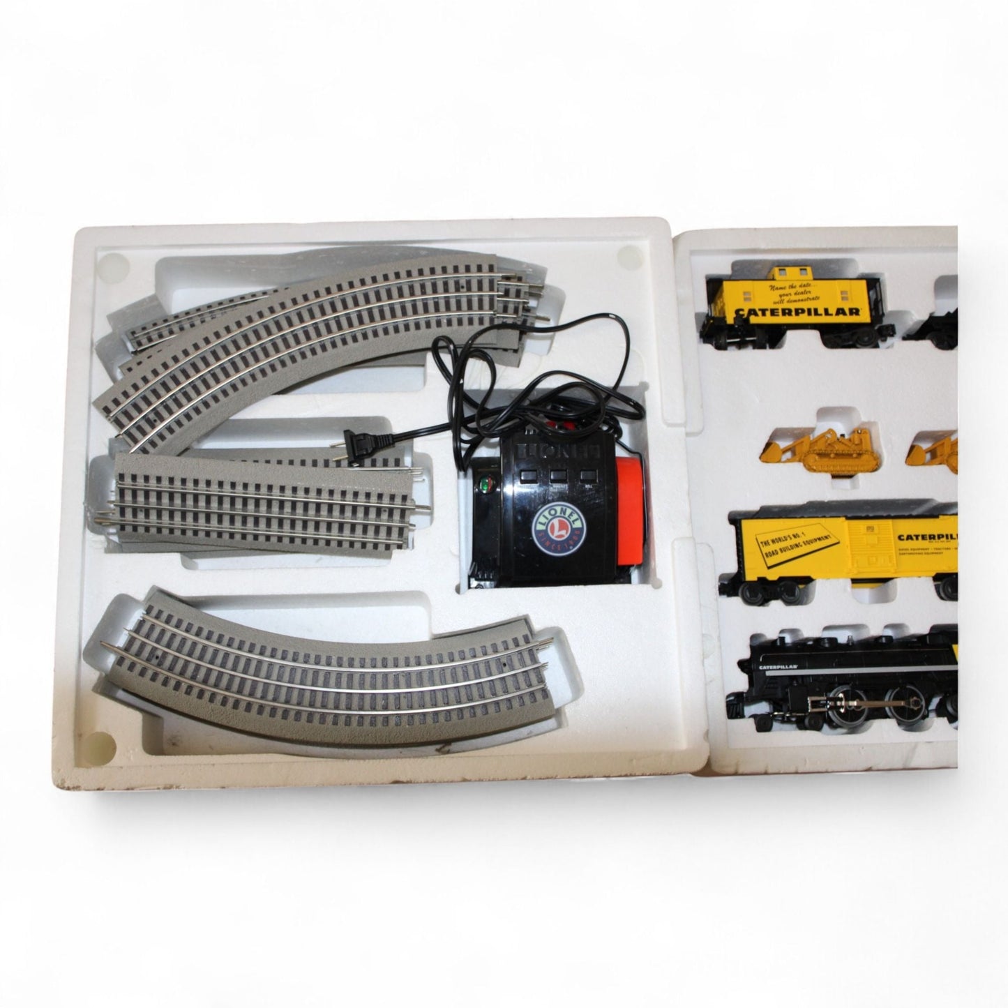 Close-up of Lionel train set components including Caterpillar branding