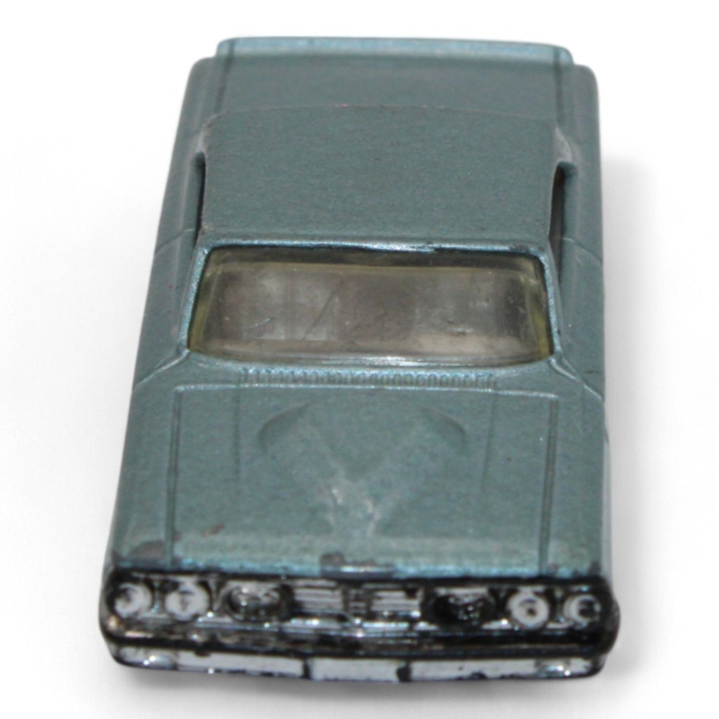 Vintage diecast model of a blue Chevy Impala, featuring chrome accents, black interior, and classic 1960s styling with minor play wear.