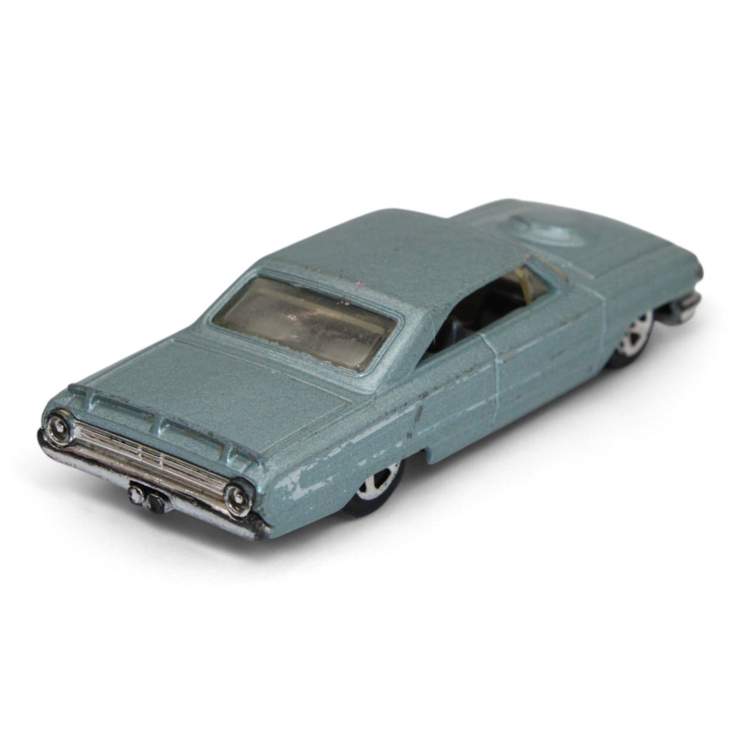 Vintage diecast model of a blue Chevy Impala, featuring chrome accents, black interior, and classic 1960s styling with minor play wear.