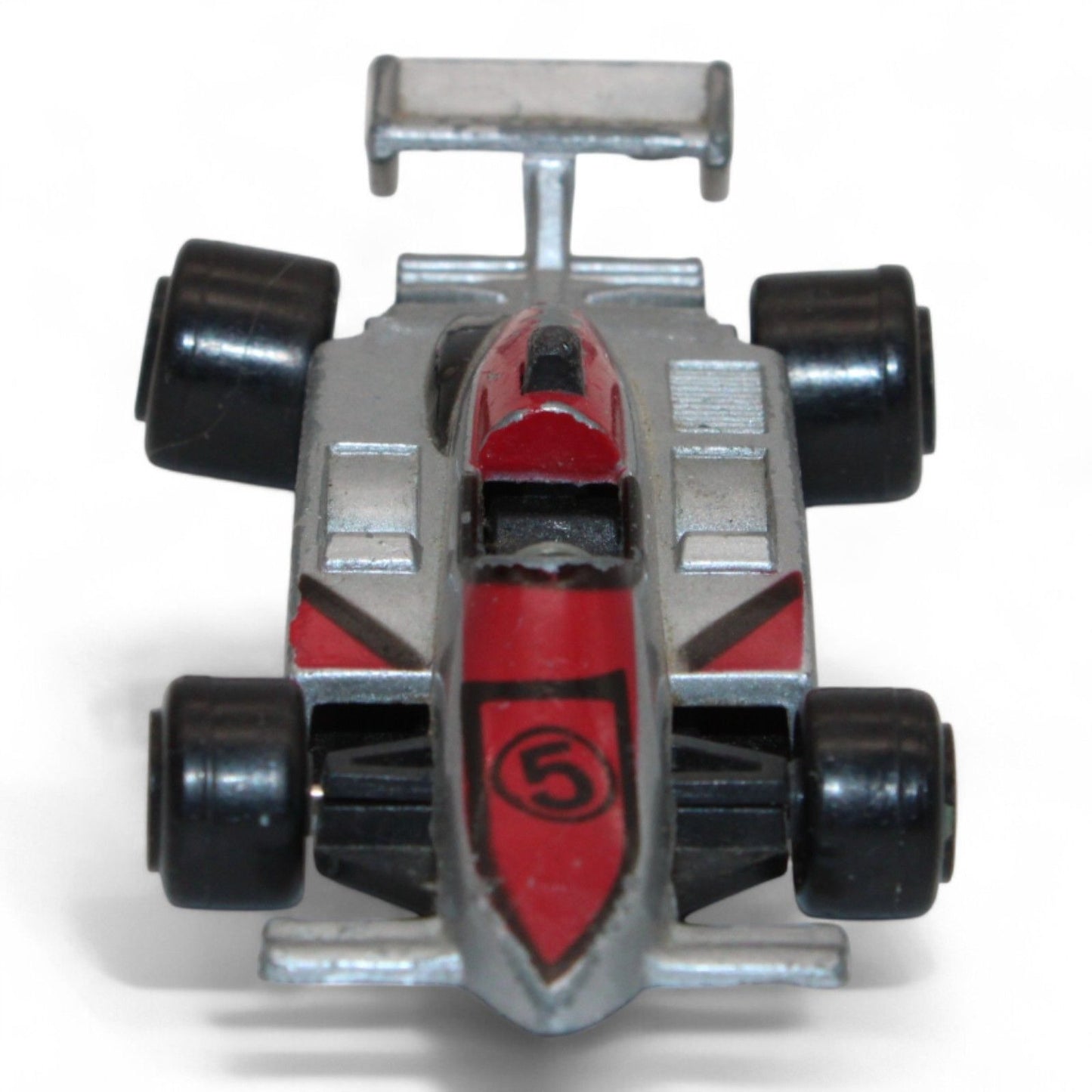 A silver and red diecast formula‑style race car toy with number 5 livery, vintage 1:64 scale metal model in fair play condition.