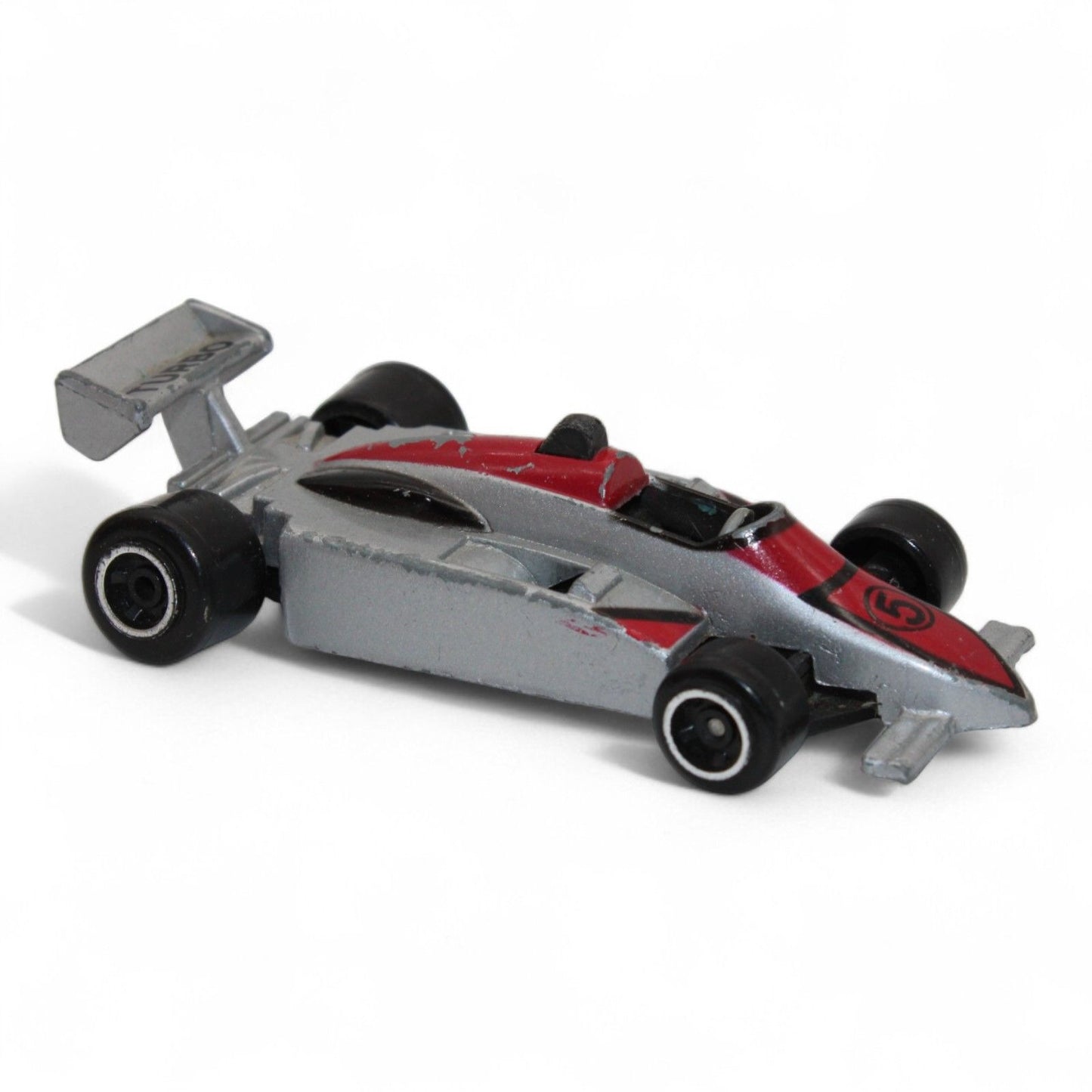 A silver and red diecast formula‑style race car toy with number 5 livery, vintage 1:64 scale metal model in fair play condition.