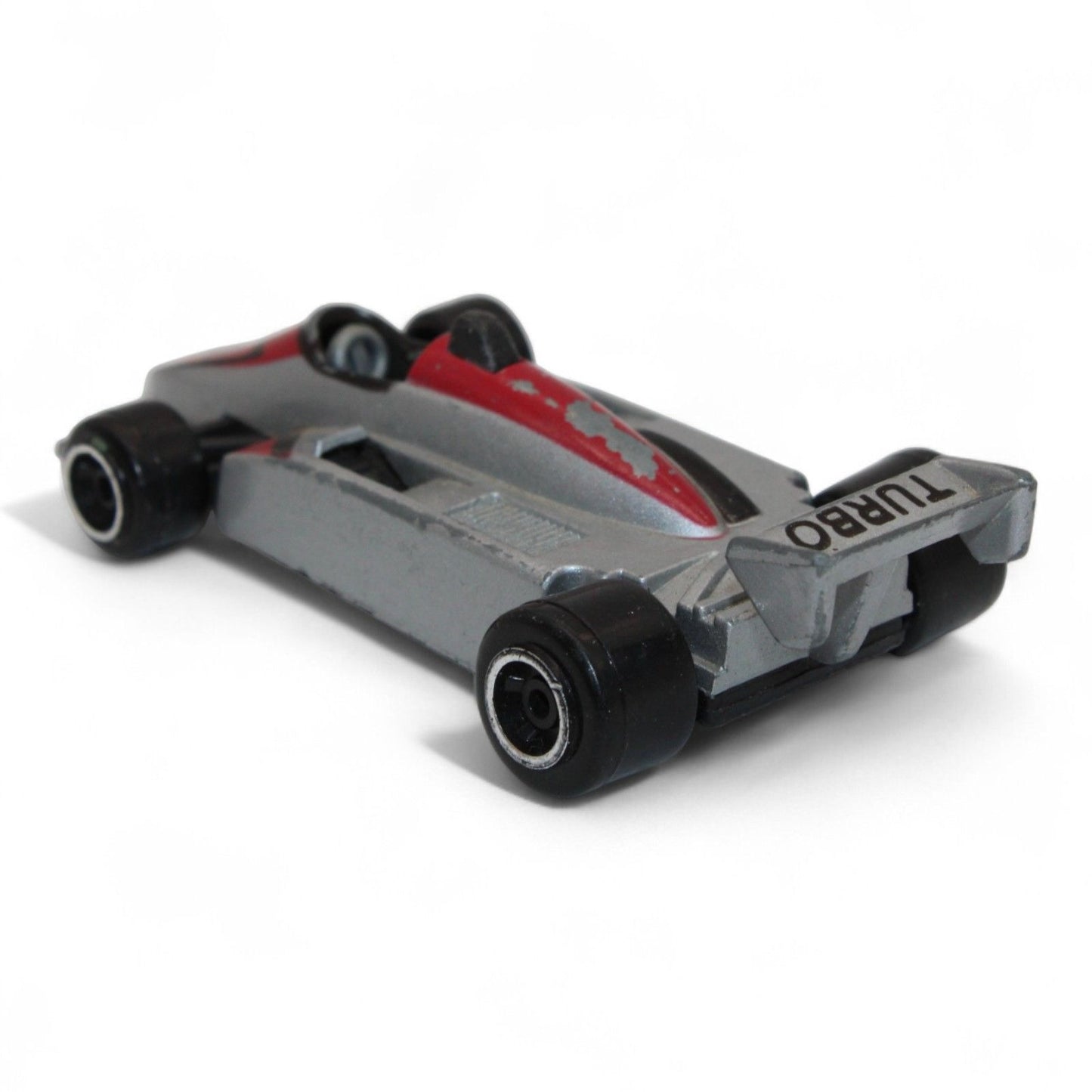 A silver and red diecast formula‑style race car toy with number 5 livery, vintage 1:64 scale metal model in fair play condition.