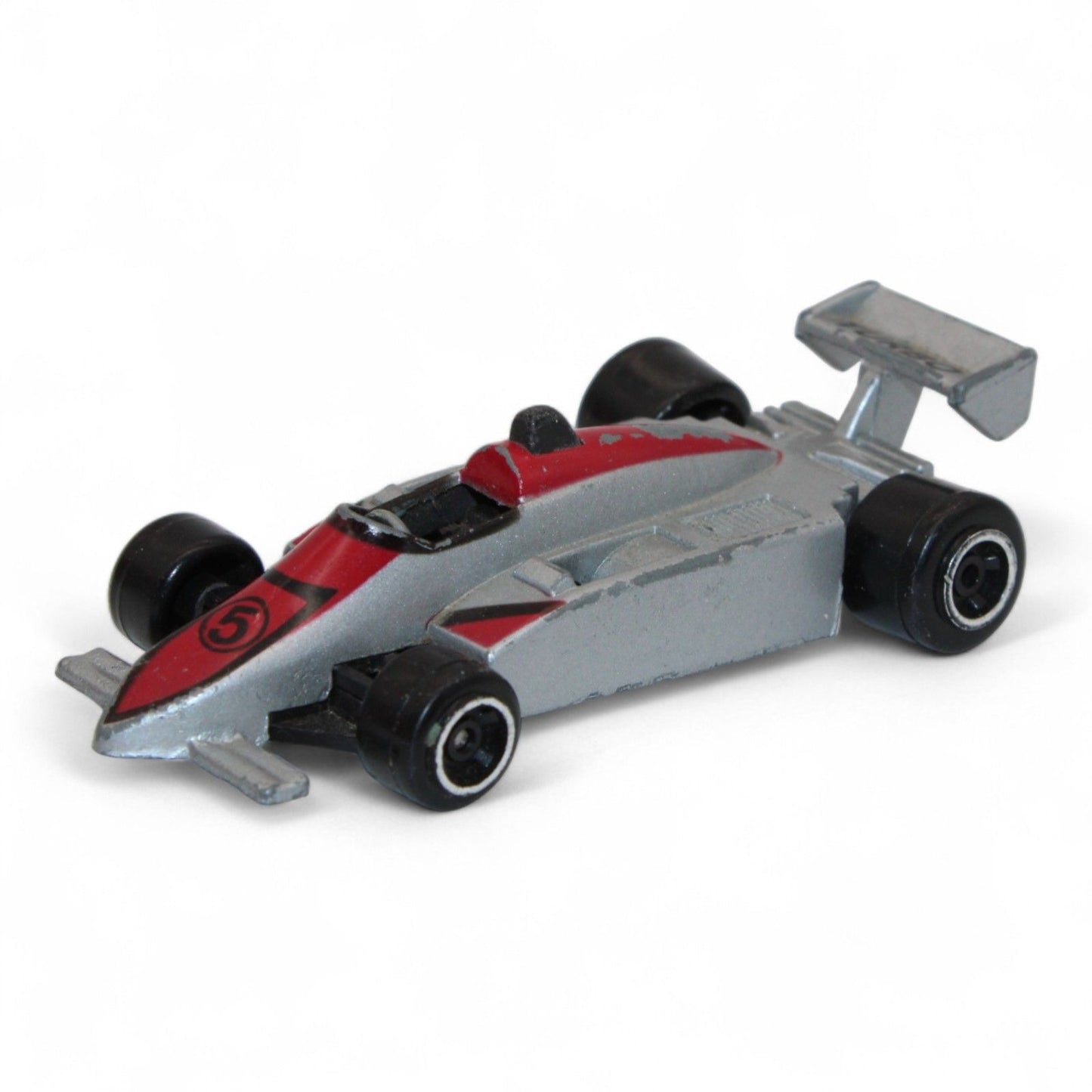 A silver and red diecast formula‑style race car toy with number 5 livery, vintage 1:64 scale metal model in fair play condition.