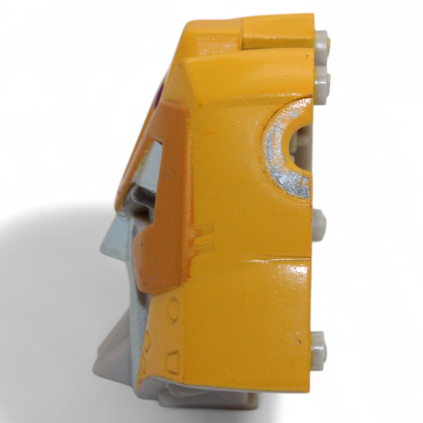 Side profile of Transformers Armada Unicron face piece, yellow and gray