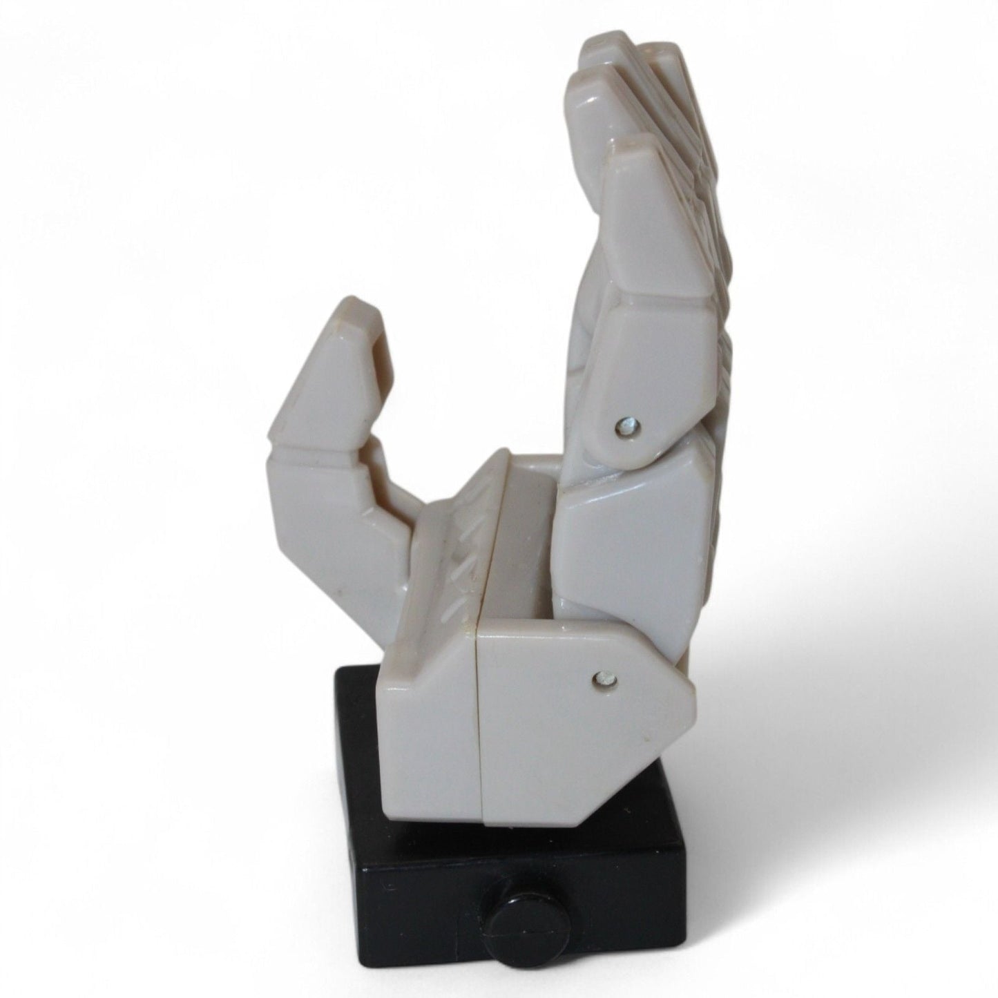 Alternate side view of Transformers Armada Unicron left hand replacement part in gray and black