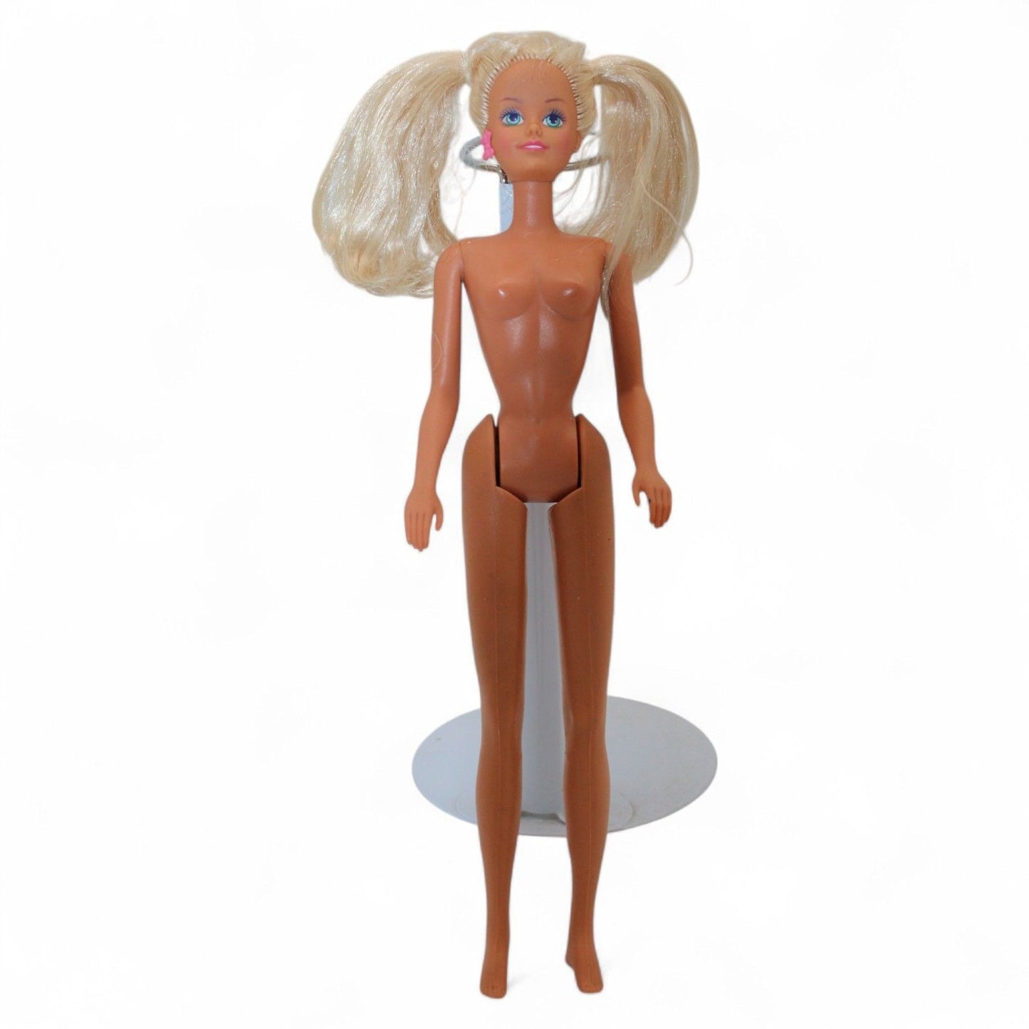 Vintage Mattel Ponytail Barbie #4 doll from 1960 with rooted blonde hair, hard plastic body, and iconic facial paint, in used condition.