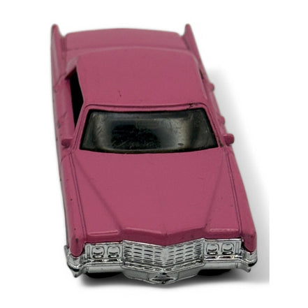 Rear view of pink Cadillac Sedan DeVille diecast