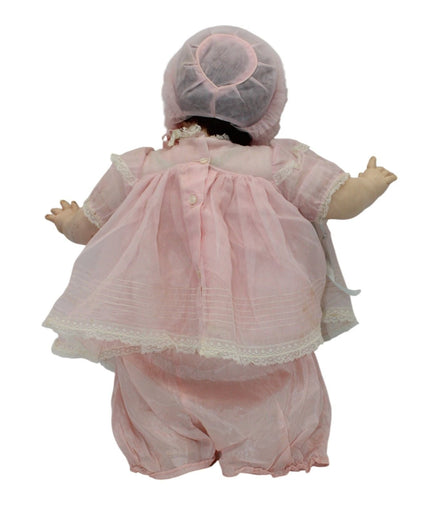 Back view of 1970s Madame Alexander Mary Mine Doll in pink dress and bonnet