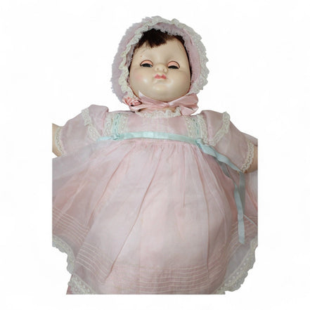 Close-up of 1970s Madame Alexander Mary Mine Doll in pink dress and bonnet