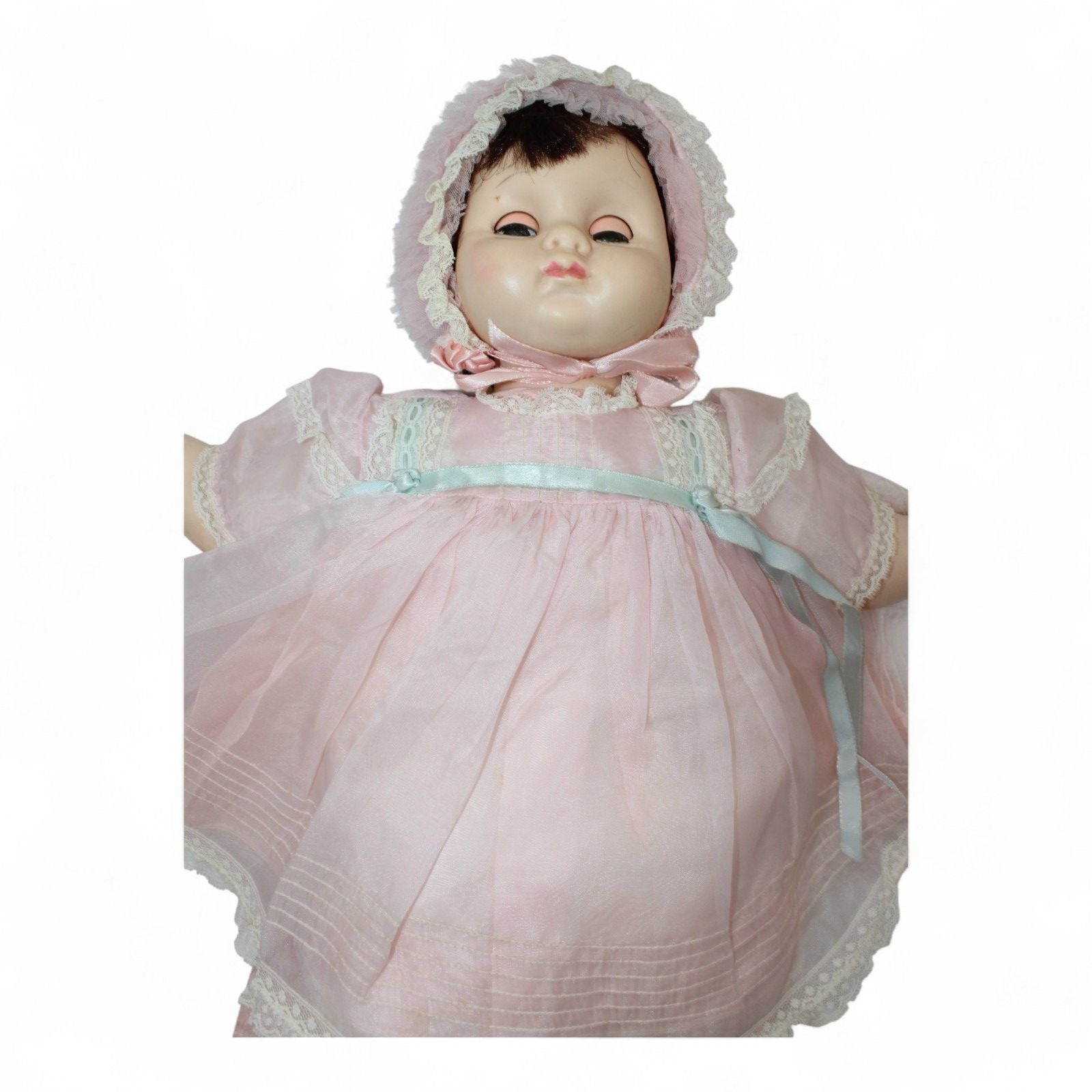 Close-up of 1970s Madame Alexander Mary Mine Doll in pink dress and bonnet