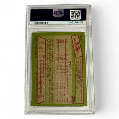 A PSA 7 near‑mint 1985 Topps #401 Mark McGwire rookie card featuring him in the 1984 USA Baseball Team uniform, an iconic Olympic‑era collectible.
