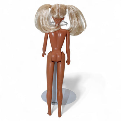 Vintage Mattel Ponytail Barbie #4 doll from 1960 with rooted blonde hair, hard plastic body, and iconic facial paint, in used condition.
