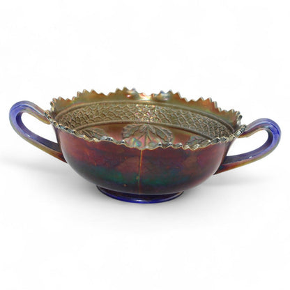 A vintage Fenton Carnival Glass cherry circles bonbon bowl with two handles, scalloped edge, and beautiful iridescent finish, excellent display piece.
