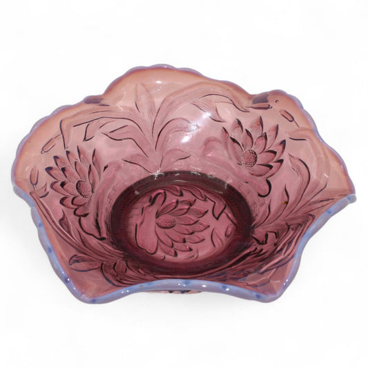 A vintage Fenton Carnival Glass ruffled bowl in grape vine pattern with iridescent amethyst tones, perfect as a decorative candy or centerpiece dish.
