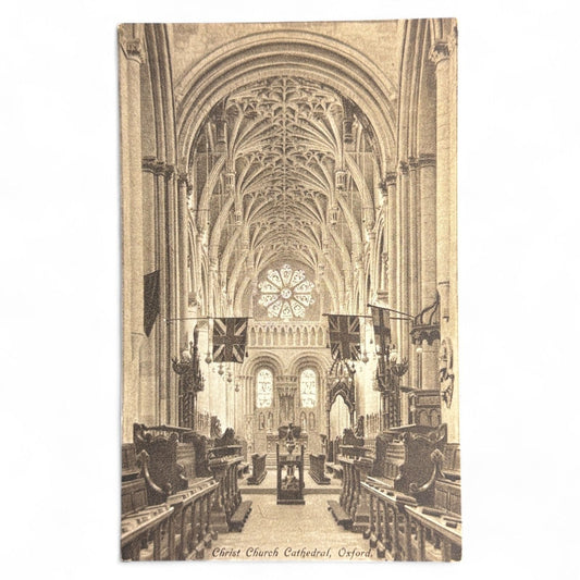 Vintage-style interior of Christ Church Cathedral, Oxford with high vaulted ceiling and stained glass window.