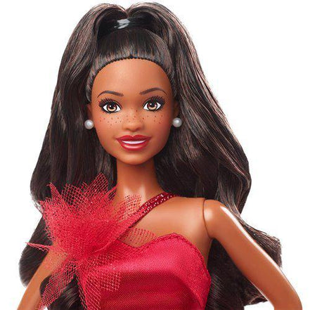 Close-up of Barbie doll with dark hair and red gown