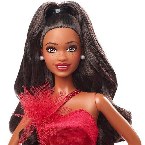 Close-up of Barbie doll with dark hair and red gown