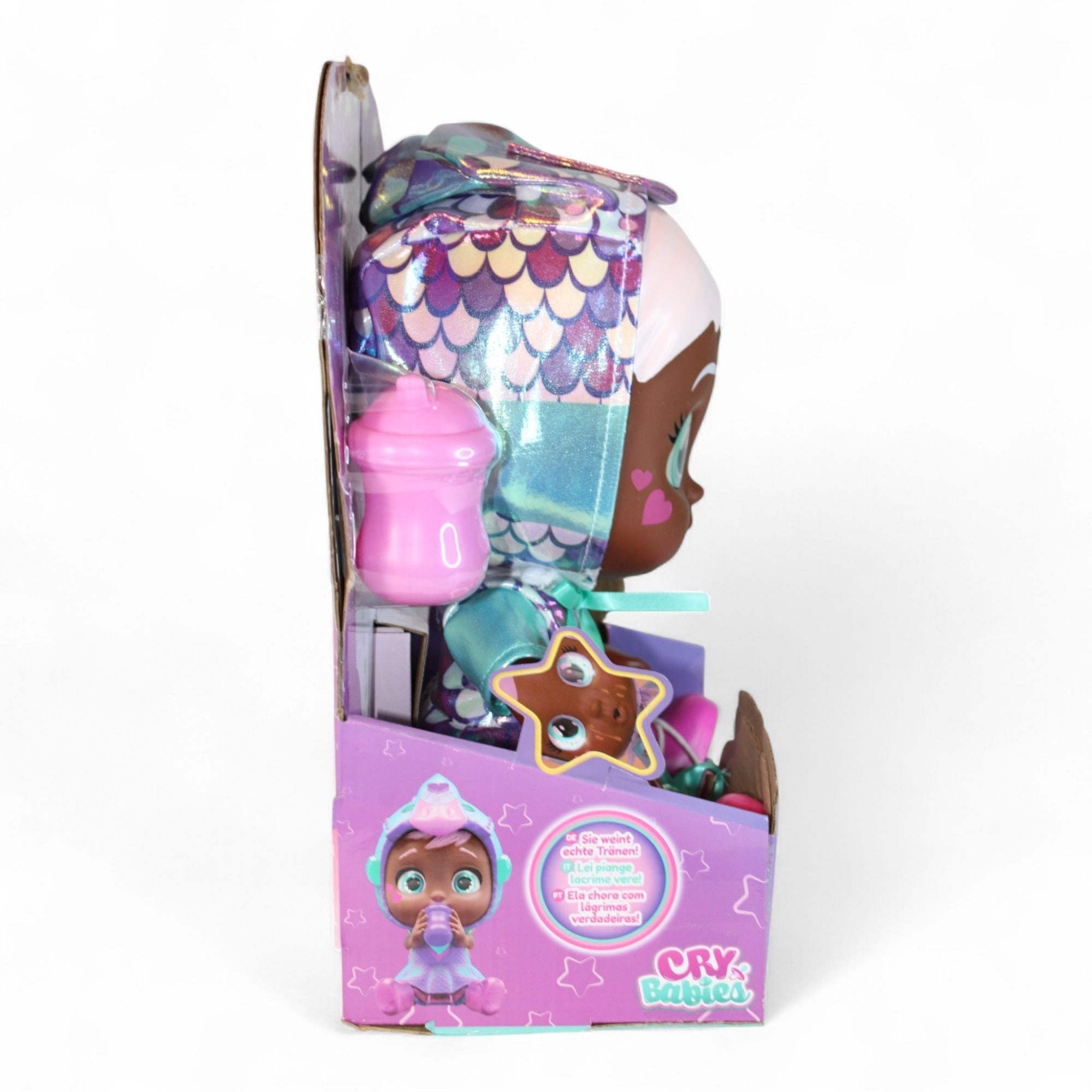 Side view of Cry Babies Ayla Doll with bottle and star accessory