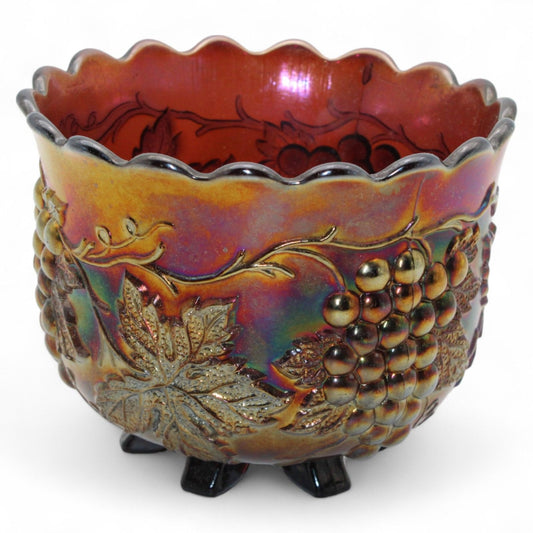 An antique Dugan Carnival Glass “Grape Delight” marigold nut bowl featuring six small feet and iridescent finish, perfect for decorative display.
