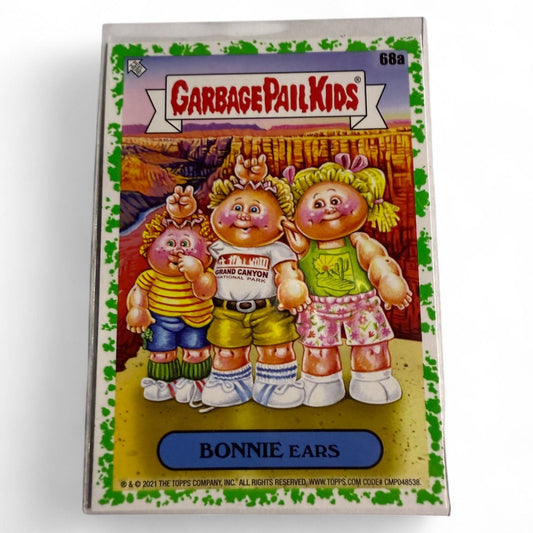 A near‑mint 2021 Topps Garbage Pail Kids #68a “Bonnie Ears” card showing three cartoon kids posing at Grand Canyon in vacation theme.  

