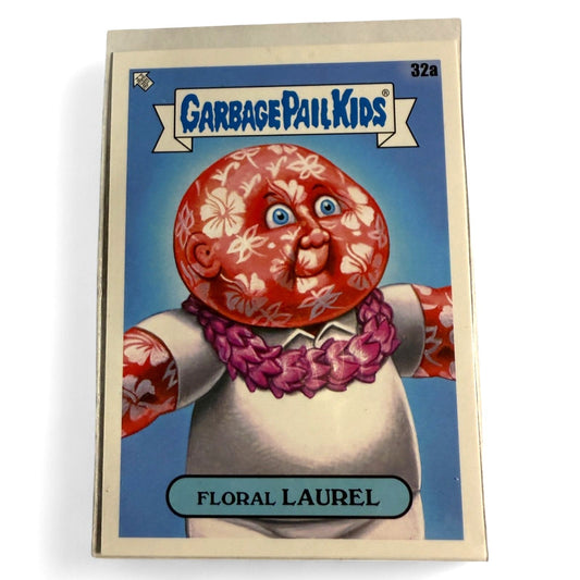 A near‑mint 2021 Topps Garbage Pail Kids #32a “Floral Laurel” card featuring a rosy‑cheeked figure with floral pattern face and aloha lei.  
