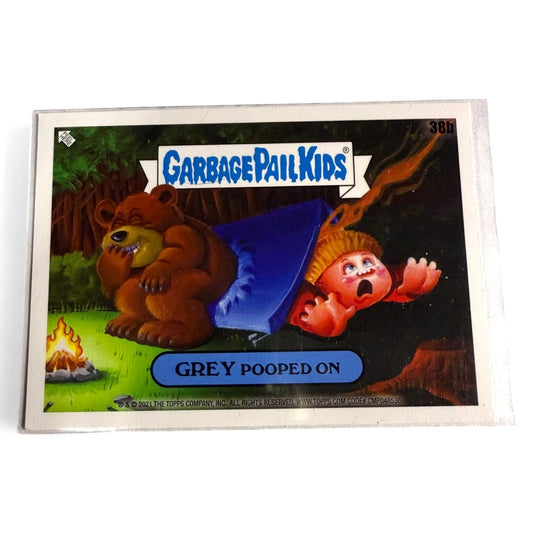 A near‑mint 2021 Topps Garbage Pail Kids #38b “Grey Pooped On” card showing cartoon bear pooping on camper, humorous horror parody collectible.  
