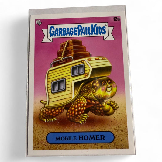 2023 Topps Chrome Garbage Pail Kids card #12a depicts Mobile Homer as a turtle-like kid with a full RV camper on his back, ready to travel.  
