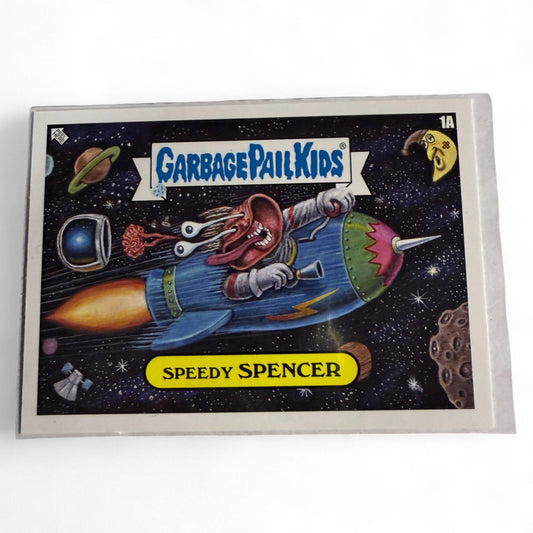 2023 Topps Chrome Garbage Pail Kids card #1a features Speedy Spencer, a wild-eyed astronaut blasting through space in a rocket ship.  
