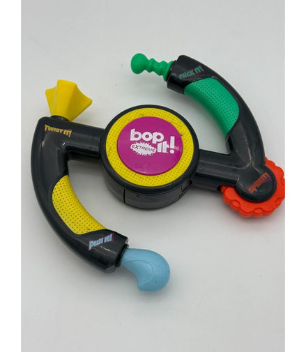 Hasbro Bop It Extreme Electronic Game showing flick, twist, pull, and spin features