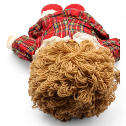 Heather doll lying down in tartan dress