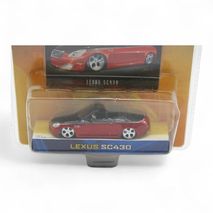 Jada Toys Dub City Lexus SC430 die-cast car in 1:64 scale features a sleek red and black finish, includes collectible trading card, new in package.
