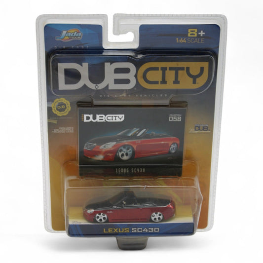 Jada Toys Dub City Lexus SC430 die-cast car in 1:64 scale features a sleek red and black finish, includes collectible trading card, new in package.
