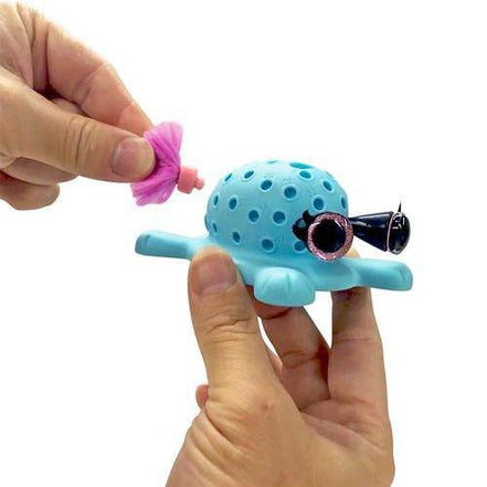 Hands assembling KaPoof Pets Miki toy with accessories
