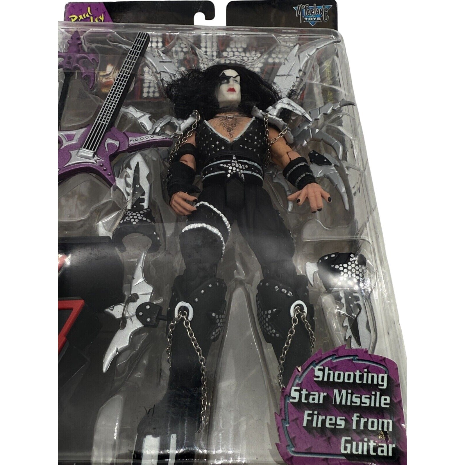 Close-up of KISS Paul Stanley action figure showing detailed costume and guitar