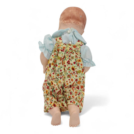 Back view of Madame Alexander doll in floral outfit