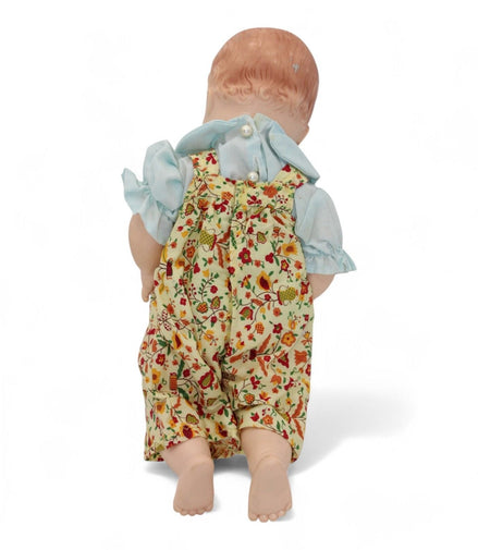 Back view of Madame Alexander doll in floral outfit