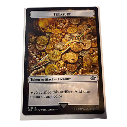 Magic: The Gathering card featuring Treasure token with gold coins and artifacts