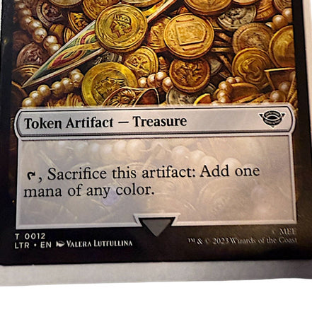 Magic: The Gathering card featuring Treasure token with gold coins and artifacts