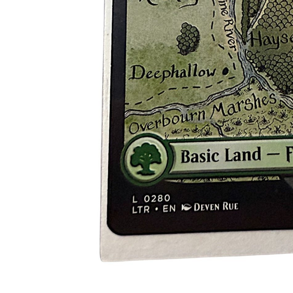 Bottom section of the Forest card with Basic Land label and artist credit
