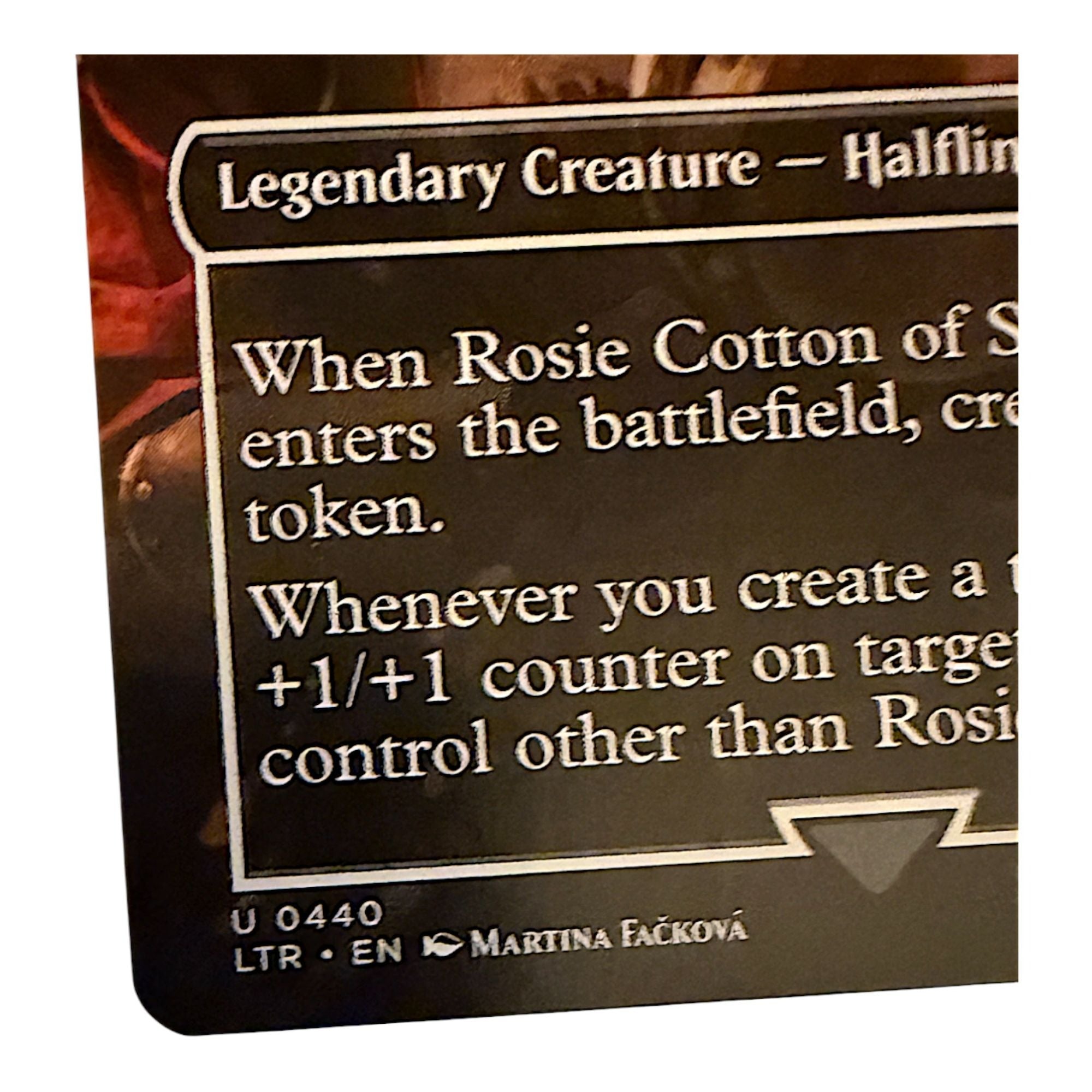 Detail of the card's collector's number and artist credit