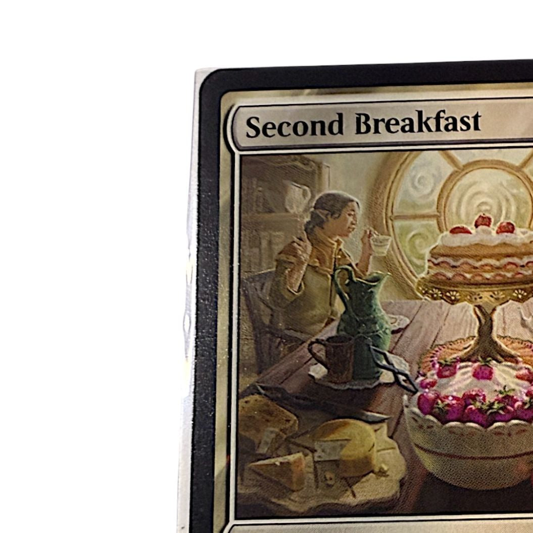 Close-up of the Second Breakfast card artwork with a hobbit enjoying breakfast