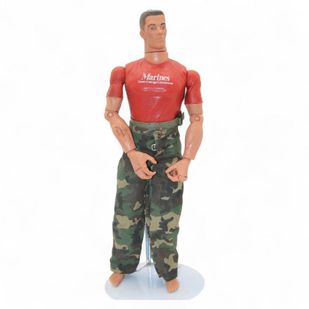 Marine action figure wearing a red shirt with 'Marines Honor Courage Commitment' and camouflage pants